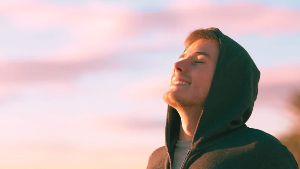 A man smiles happily off in the distance