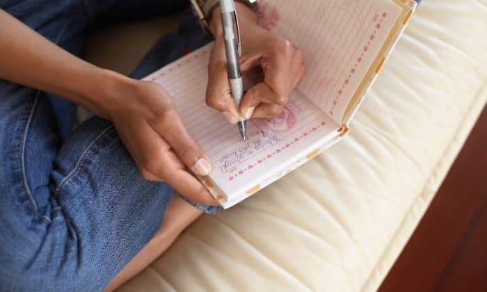 woman journaling to work through self forgiveness in sobriety