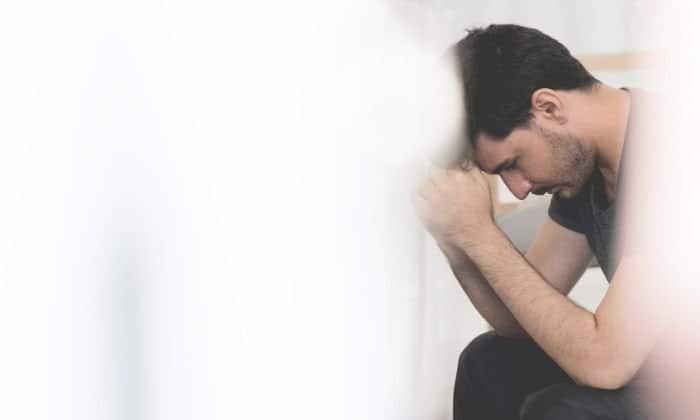 man 30 days sober sitting down with hands on knees