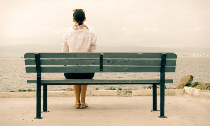 woman sitting on bench working through her anxiety