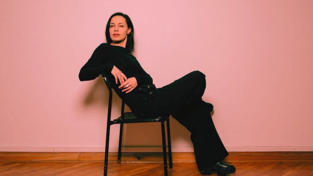 A confident woman reclines in her chair
