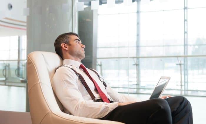man with anxiety sitting on chair staring out of window