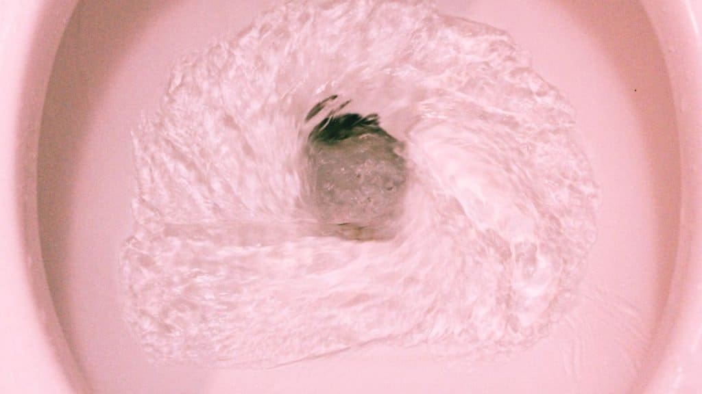 Close up of a toilet flushing