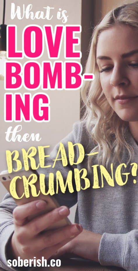Close up of a woman in a grey sweatshirt with blonde hair staring down at her phone behind the title What is love bombing then breadcrumbing and the URL soberish.co