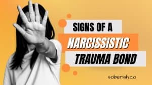 A woman in grayscale holds her hand up to the camera, covering her face. The title reads "Signs of a Narcissistic Trauma Bond"