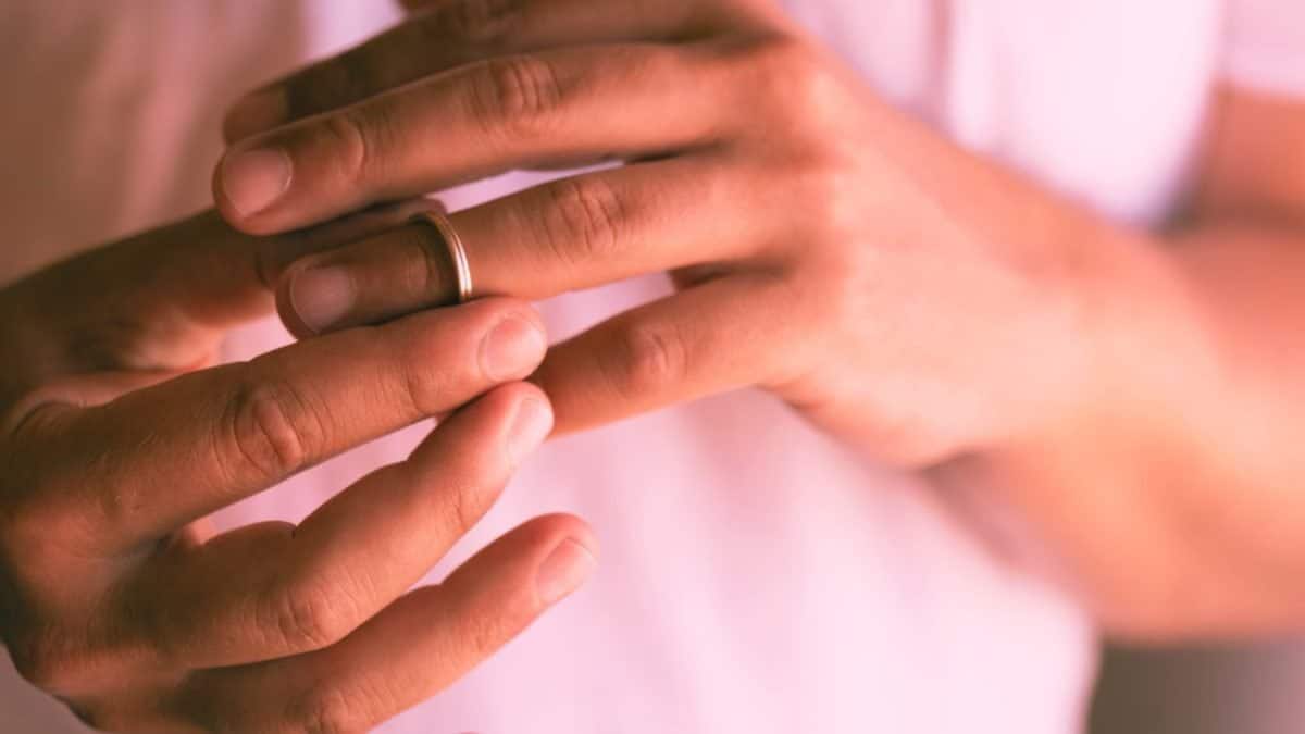 A woman contemplating leaving her alcoholic husband removes her wedding ring