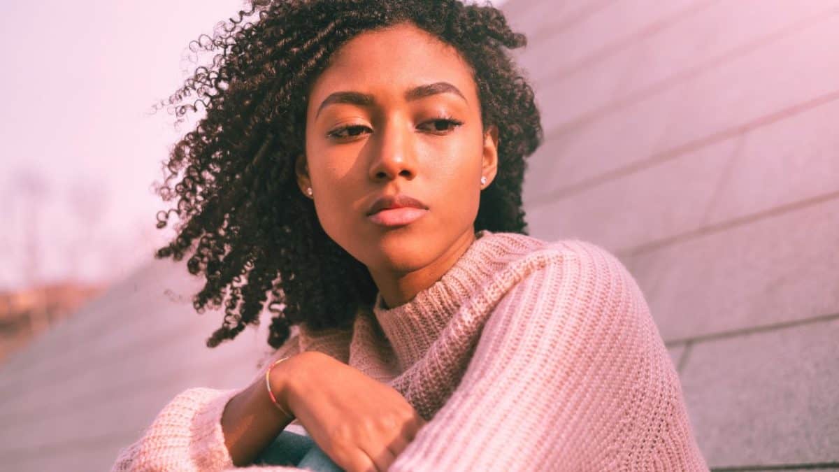 A woman stares pensively out into the distance after ghosting someone