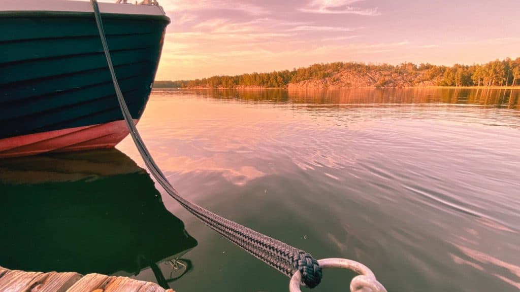 A boat is tied to a dock symbolizing an inability to let go