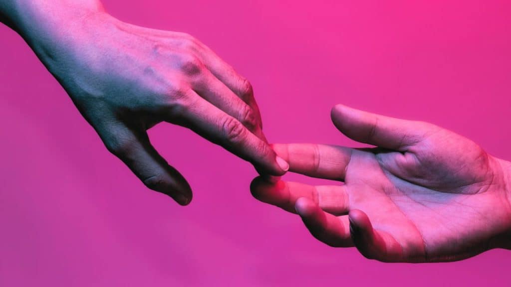 Two hands let go of each other indicating a separation