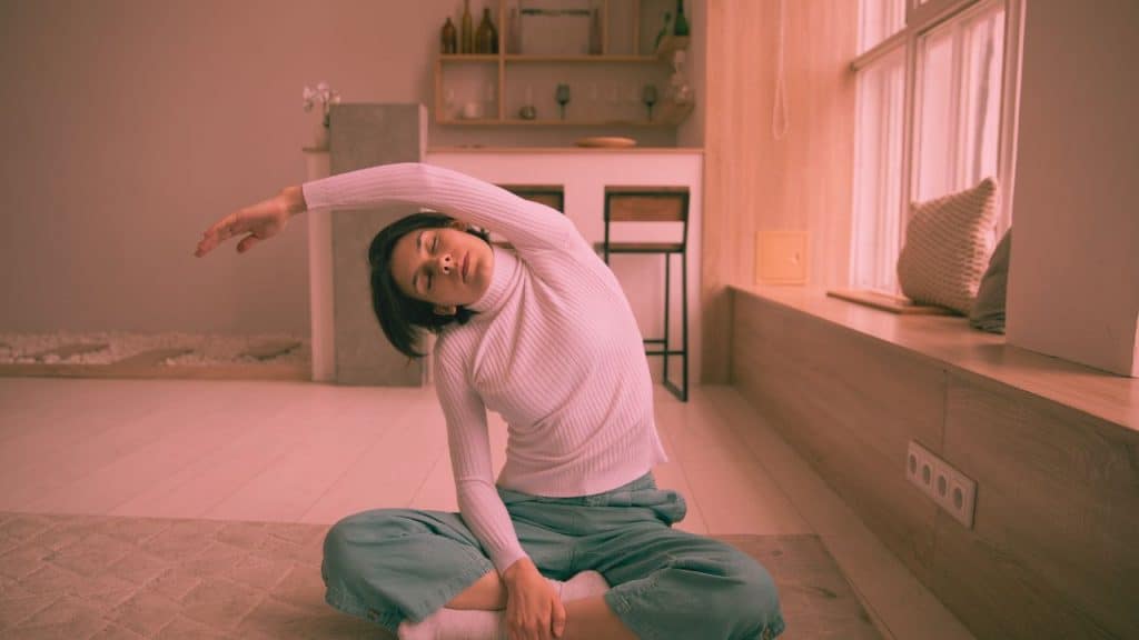 sober woman stretches as part of her routine to maintain sobriety