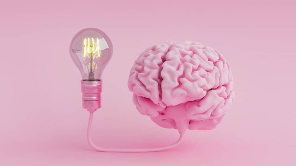 Pink brain connected to a lightbulb