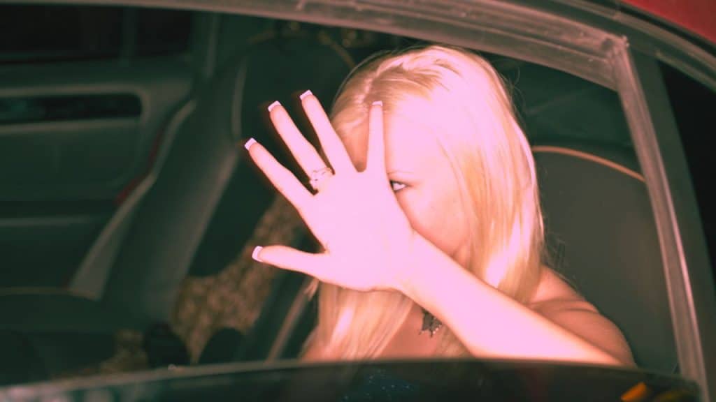 A woman with a distorted self-image shields her face from being seen