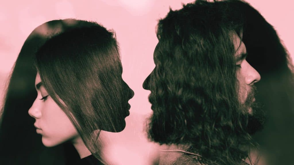 An artistic image of a codependent couple where half of their profile looks towards each other, and the other half away