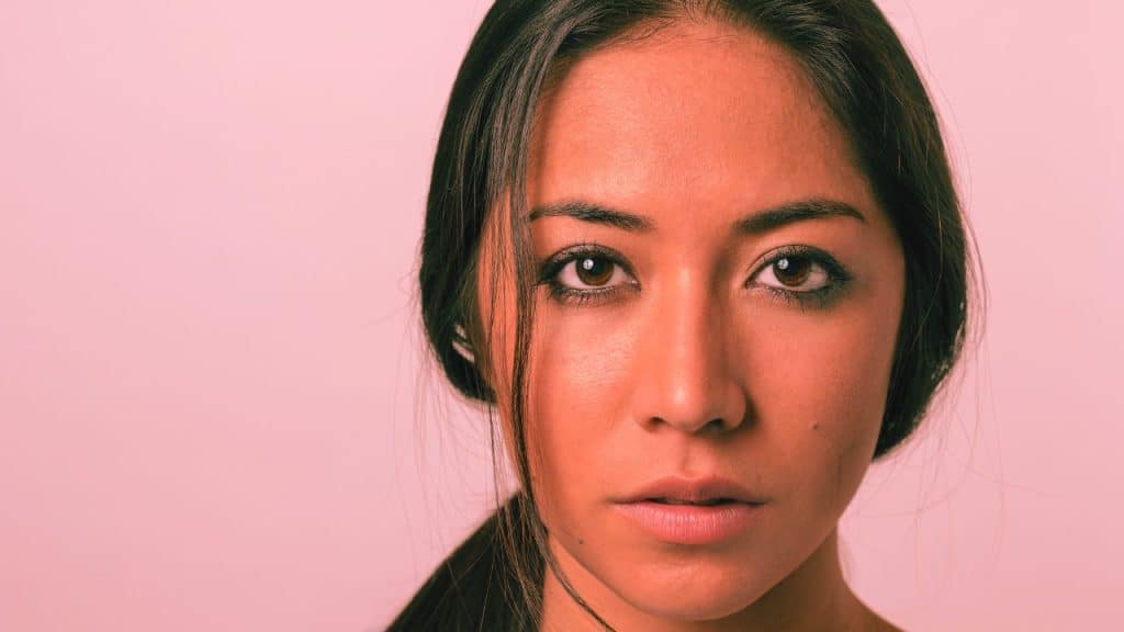 A woman stares blankly into the camera. Is it zoning out or dissociating?