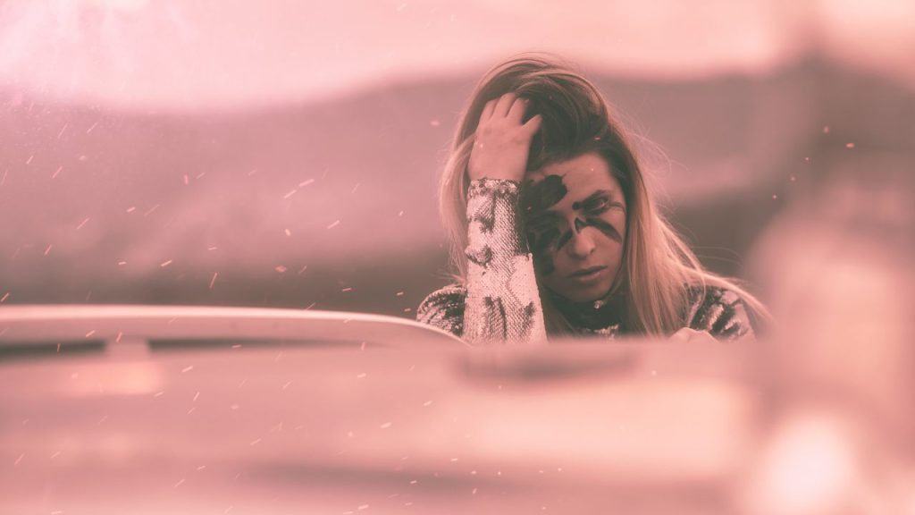 A woman is stressed and leans against her hand. She wrestles with emotional reasoning