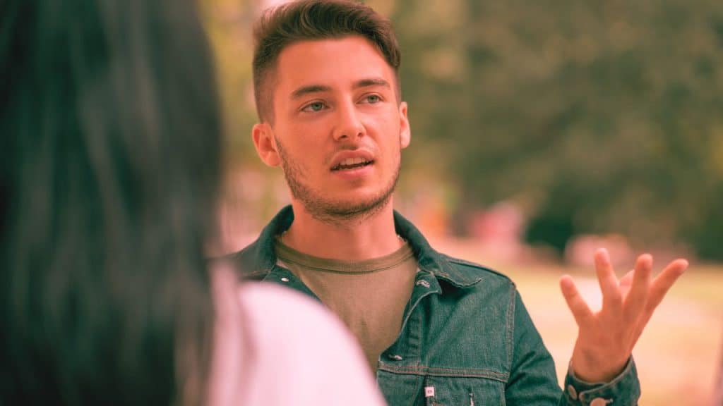 A man in recovery from alcohol addiction speaks to a woman about his boundaries
