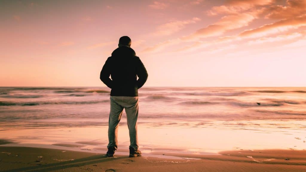A man in sobriety stares out to the sea