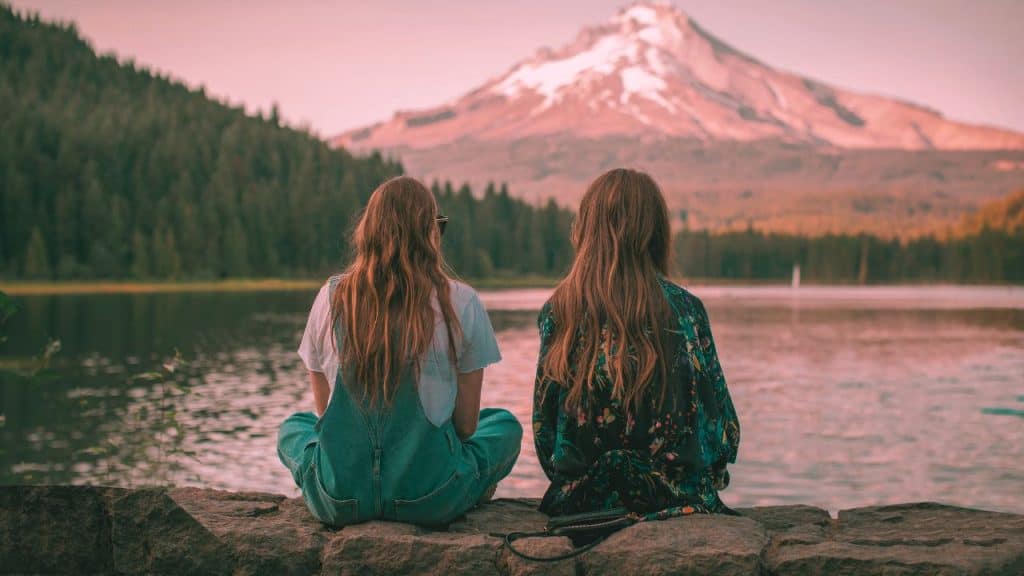 A woman sits with her BPD favorite person staring out at a peaceful lake