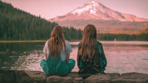 A woman sits with her BPD favorite person staring out at a peaceful lake